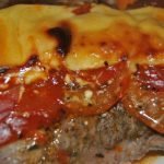Chuletas al horno con queso y tomate